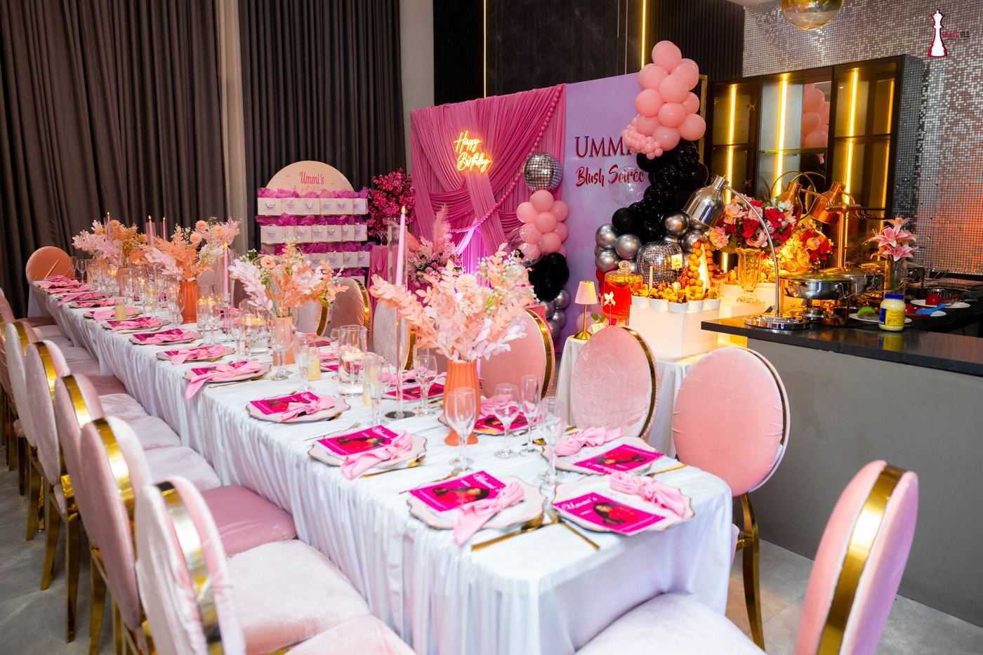 Long blush-pink dinner table styled with florals and place settings for a birthday soirée