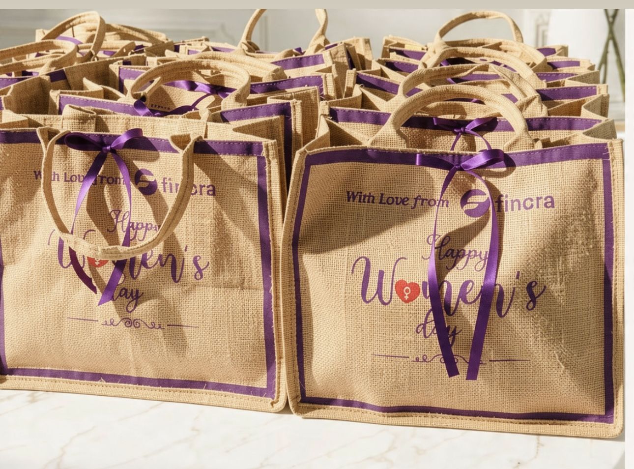 Rows of branded corporate gift tote bags for a company celebration